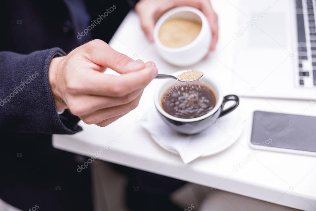 Focused photo on male hand that holding teaspoon
