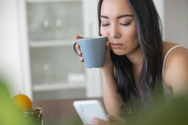 Sad beautiful woman using her mobile phone — Stock Photo, Image