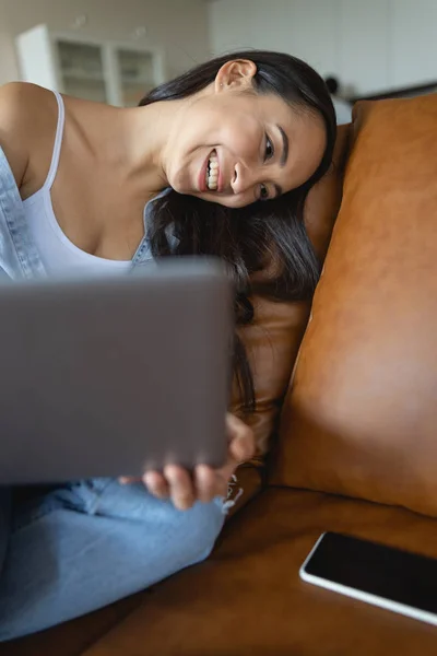 High-spirited young woman lying on a cushion — Stock Photo, Image