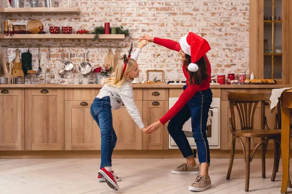 Woman and a girl dancing on Christmas eve — Stock Photo, Image