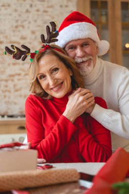Partnerinin ellerine dokunan çekici, olgun bir kadın.