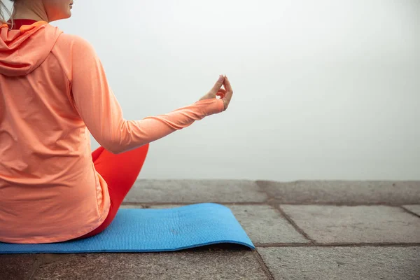 Леді сидить на йога килимок і роздумує на відкритому повітрі — стокове фото