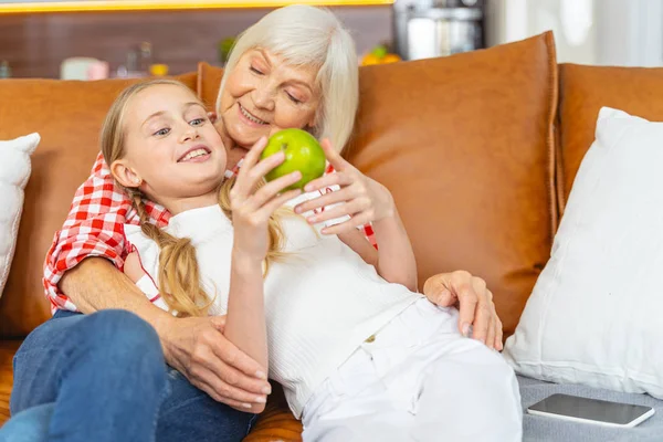 Pleased senior lady looking at her grandchild — Stock Photo, Image