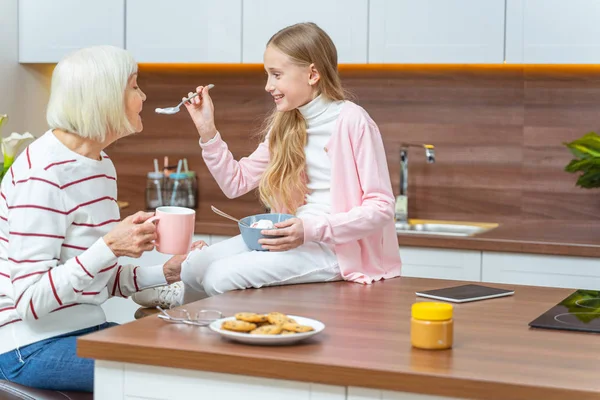 Female reaching for a spoon with ice cream — Stock Photo, Image