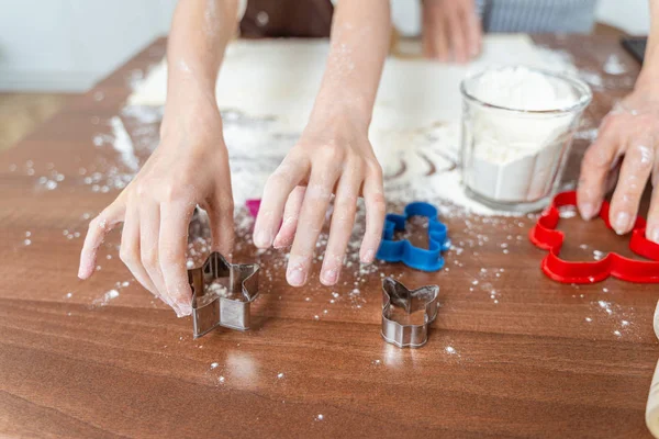 Hands of two women holding baking utensils — Stock Photo, Image