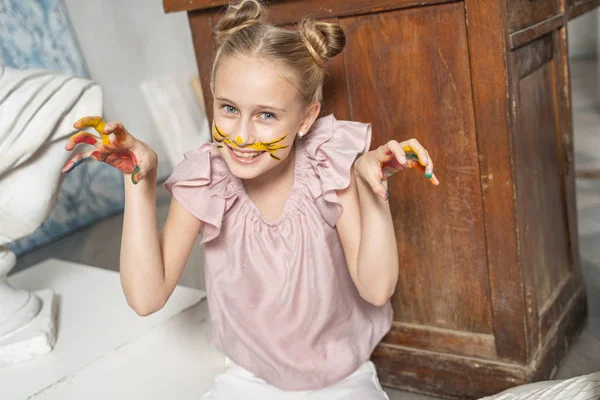 Small nice girl with painted coloured palms having fun — Stock Photo, Image