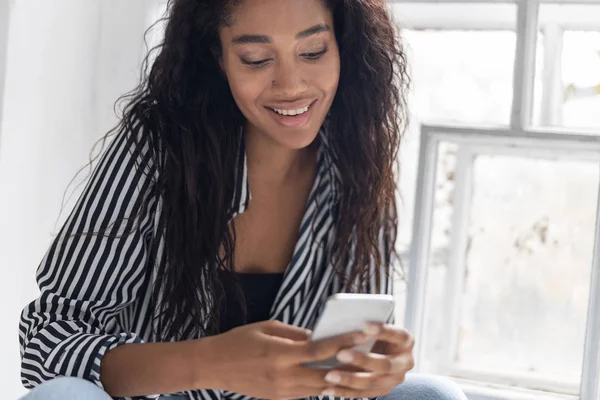 Sonriente chica con camisa a rayas descansando en casa — Foto de Stock