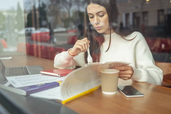 Attentive female person reading book during break — 스톡 사진