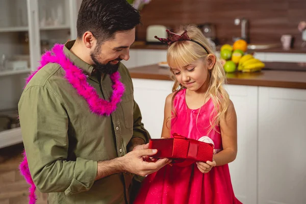 Happy father giving birthday present to his daughter