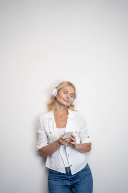 Woman with closed eyes listening to music