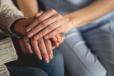 Young medical worker supporting her mature patient