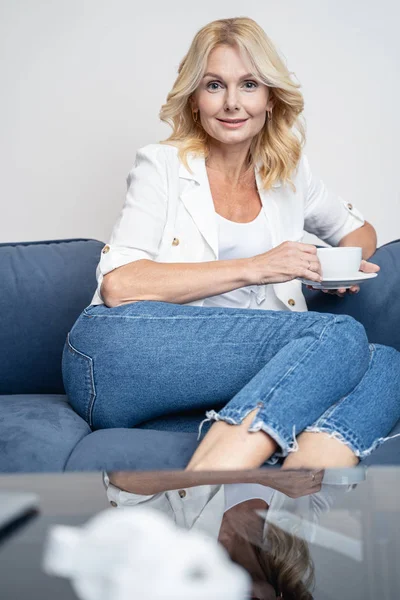 Smiling contented lady having a coffee break — Stock Photo, Image