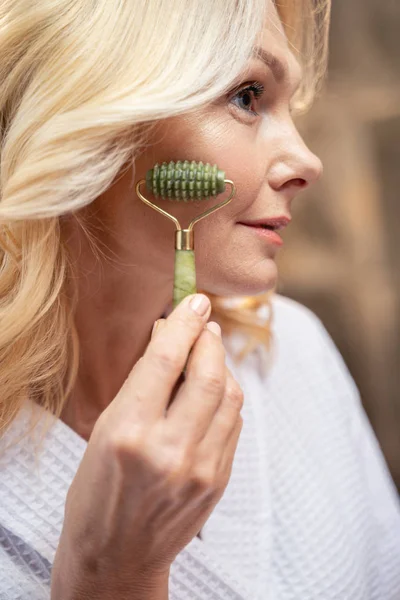 Good-looking lady giving herself a facial massage — 스톡 사진