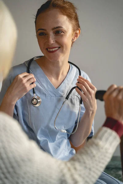 Close up of pleased girl that being in medical uniform — 스톡 사진