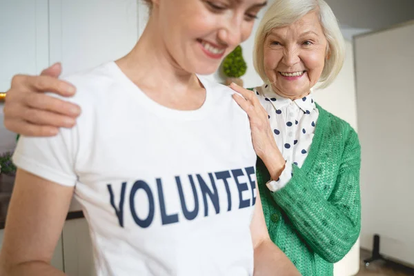 Pleased mature woman caressing her social worker — Stok fotoğraf