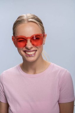 Dudakları parıltılı beyaz kız kameraya poz veriyor.