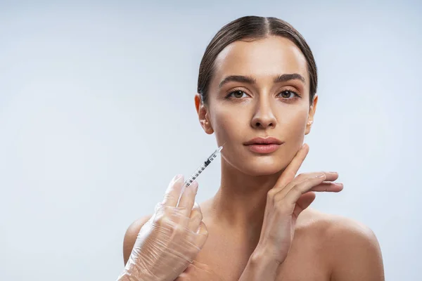 Calm tender girl is ready for beauty procedures against light background — 스톡 사진