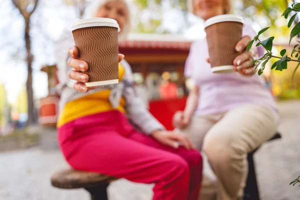 Vrienden die geurige koffie drinken in het park — Stockfoto