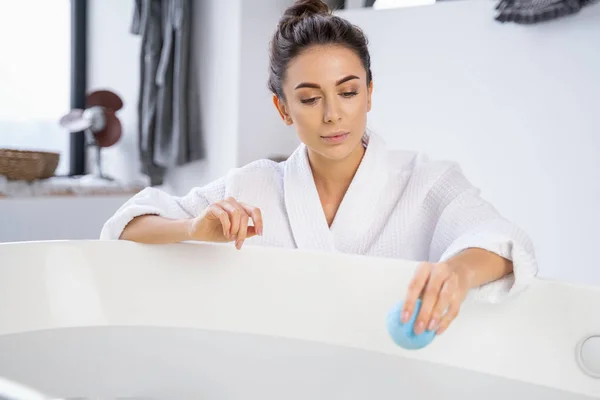 Young woman gazing at a bath ball — Stock Photo, Image