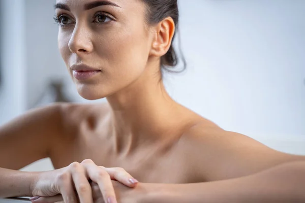 Serene beautiful woman sitting in a bathtub — Stock Photo, Image