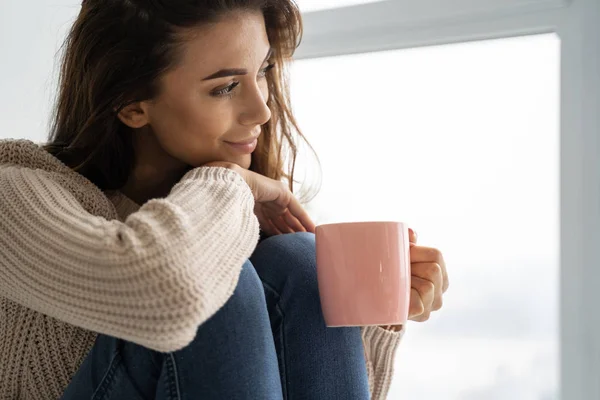 Pleased girl drinking a cup of tea — Stock Photo, Image