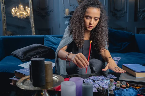 Focused young woman holding a wax candle — 스톡 사진