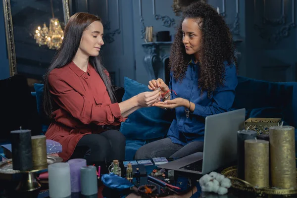 Smiling modern soothsayer staring at her client — Stock Photo, Image