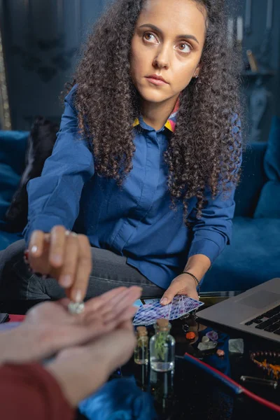 Beautiful soothsayer looking at her female client — Stock Photo, Image