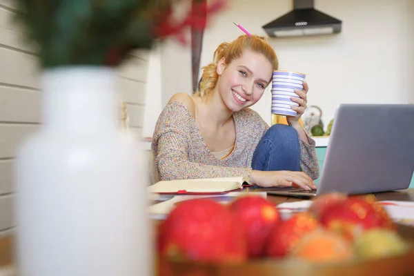 Happy blonde girl working at home alone — Stock Photo, Image