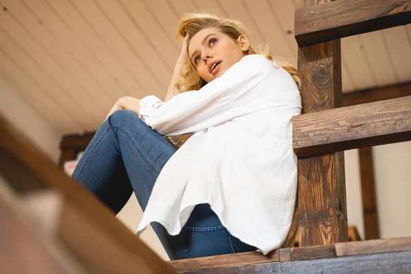 Emotional young woman looking straight at window — Stock Photo, Image