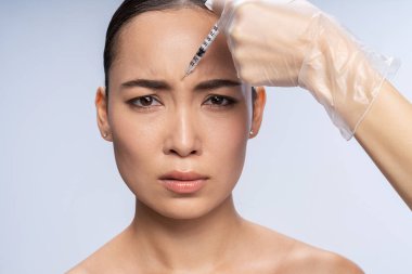 Portrait of emotional girl that doing injection