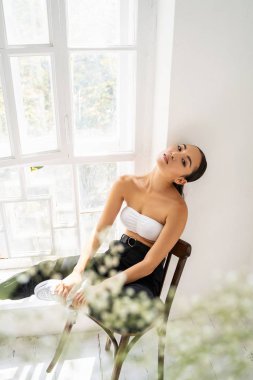 Relaxed young female person sitting on chair