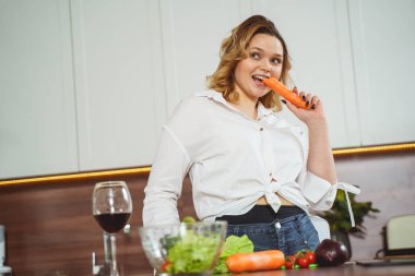 Attractive curly haired girl eating healthy food