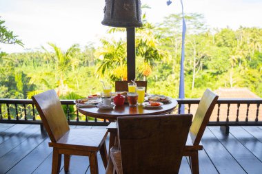 Açık kafede kahvaltılı sandalyeler ve masa.