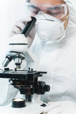 Attentive international lab assistant observing chemical reaction
