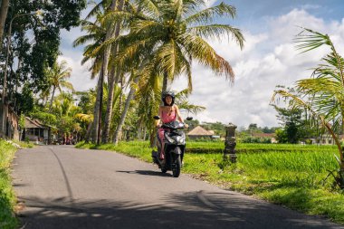 Active young female person riding her motor bike