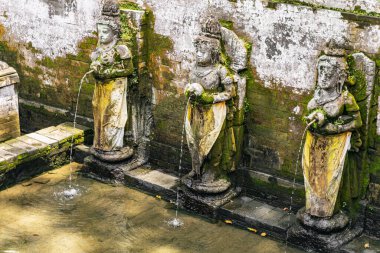 Close up of stone goddesses that standing on support