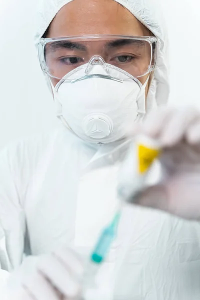 Attentive international medical worker staring at pharmacy