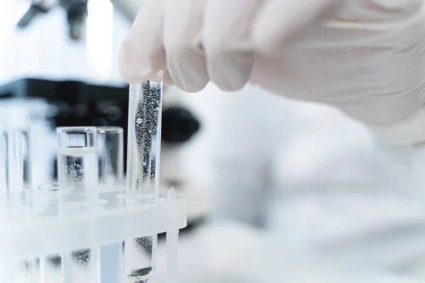 Focused photo on hand that taking test tube — Zdjęcie stockowe