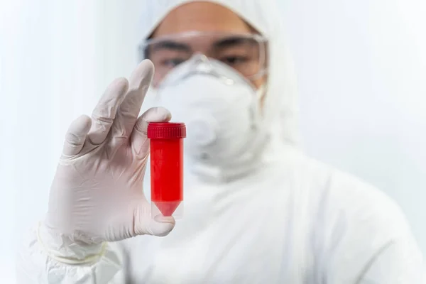 Competent international scientist staring at plastic package — Stockfoto