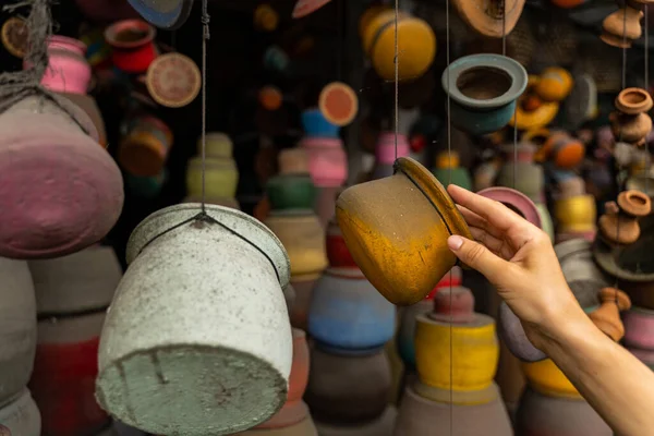 Young female person choosing yellow pot for herself — Stok fotoğraf