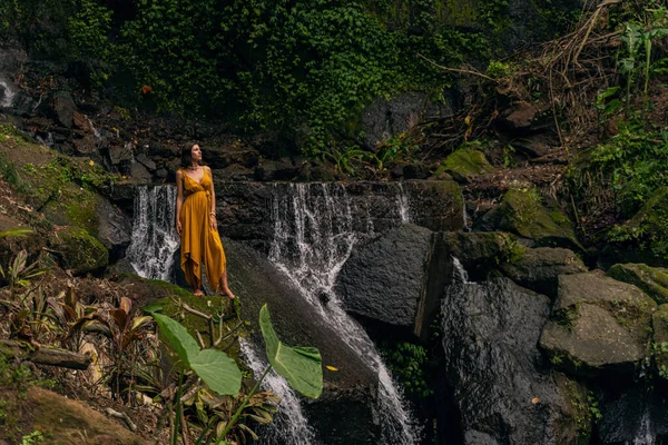 Relaxed international woman standing on big stone — Stock Photo, Image