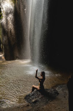 Slim young woman spending her time with pleasure