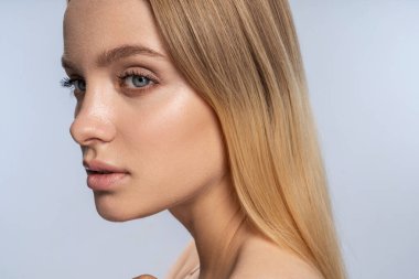 Cute serene young female lost in reverie