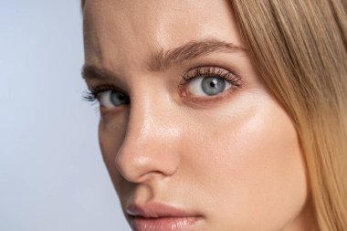 Pretty tranquil Caucasian young lady staring forward