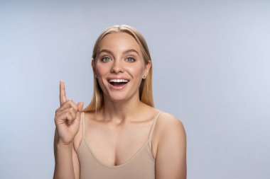 High-spirited girl in a beige tank top