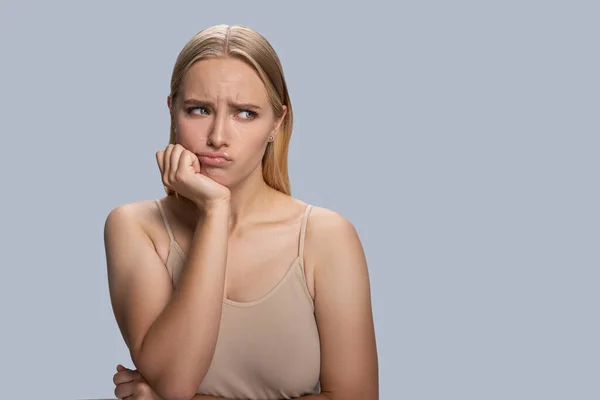 Irritated beautiful lady with her chin propped — Zdjęcie stockowe