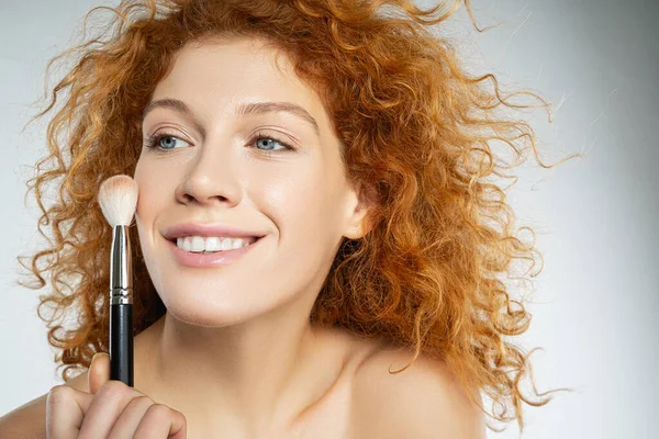 Positive delighted young female person holding brush — Stok fotoğraf