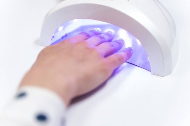 Professional ultraviolet lamp being in use for client