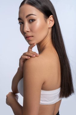 Brunette woman looking at camera and smiling